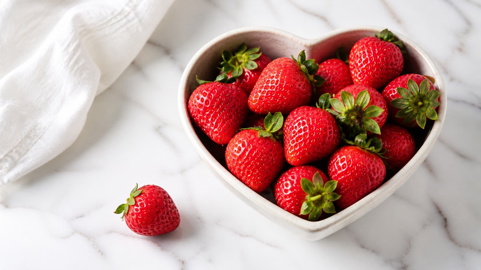 Heart shape formed from fresh strawberries, representing the cardiovascular health implications of high saturated fat intake on the carnivore diet