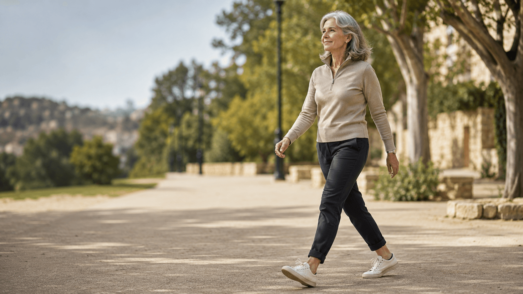 An adult over 40 on an unhurried daily walk outdoors in sportswear, showing active recovery in practice — the low intensity movement that fills the rest days in the simple weekly training framework above and quietly drives long term progress